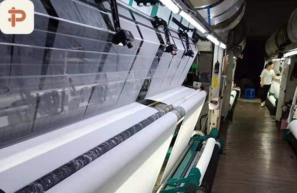 Finishing and raising line with fabric running over the machine bed
