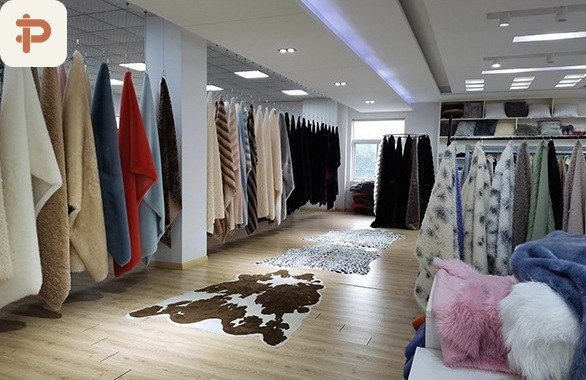 Showroom at the mill with plush and faux-fur fabric on hangers